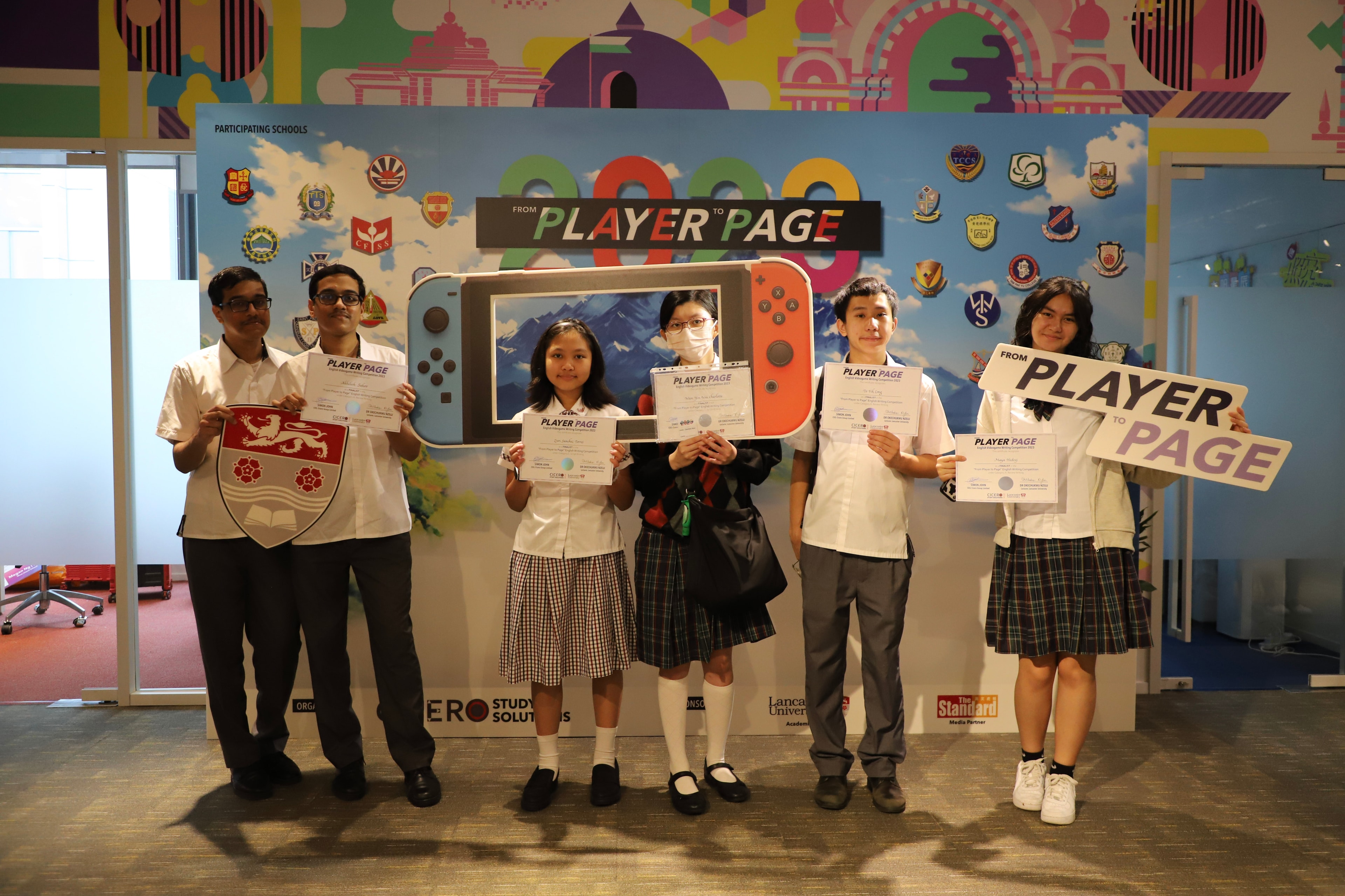 Students holding From Player to Page certificates