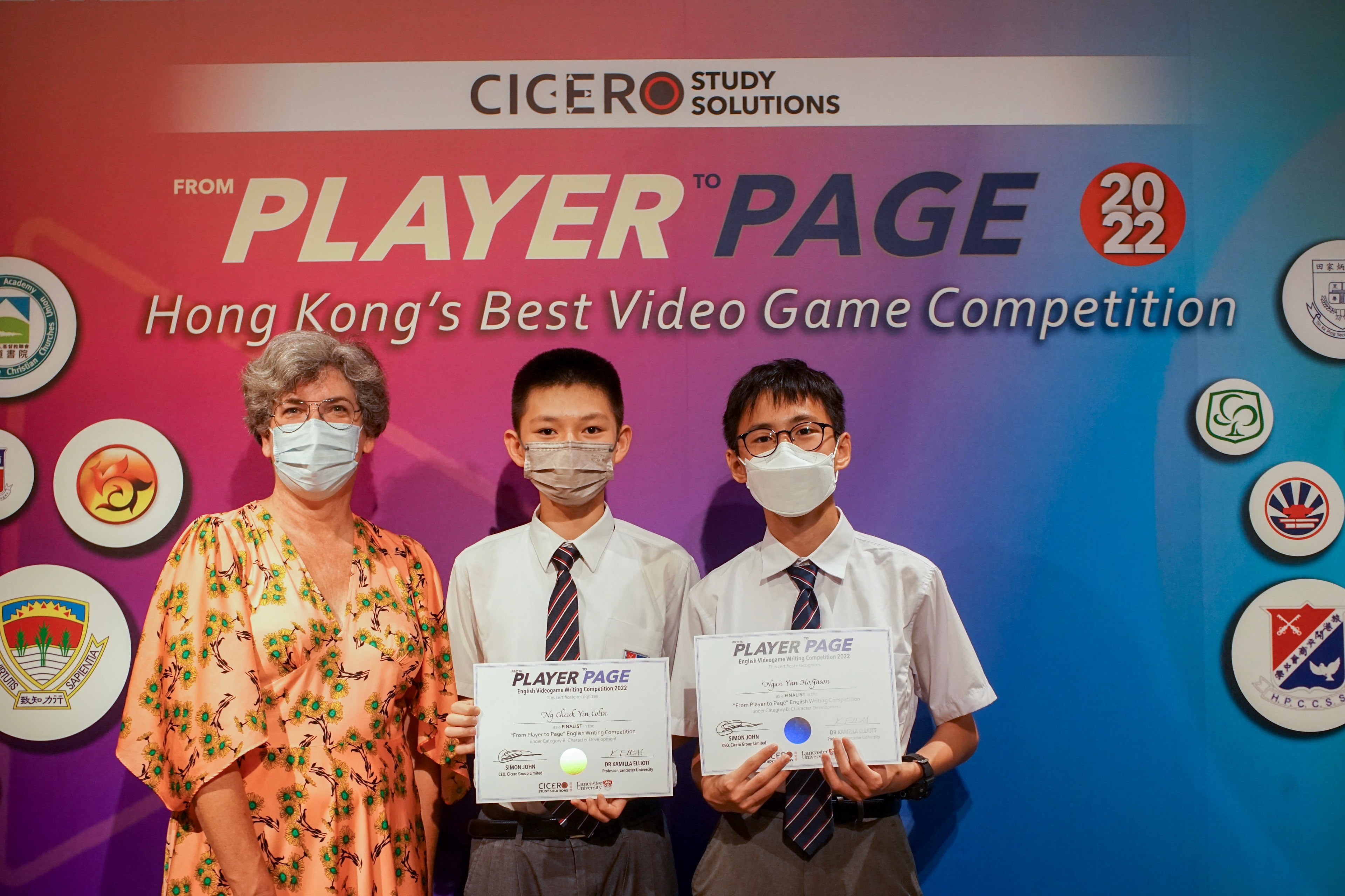 Video game competition winners holding certificates