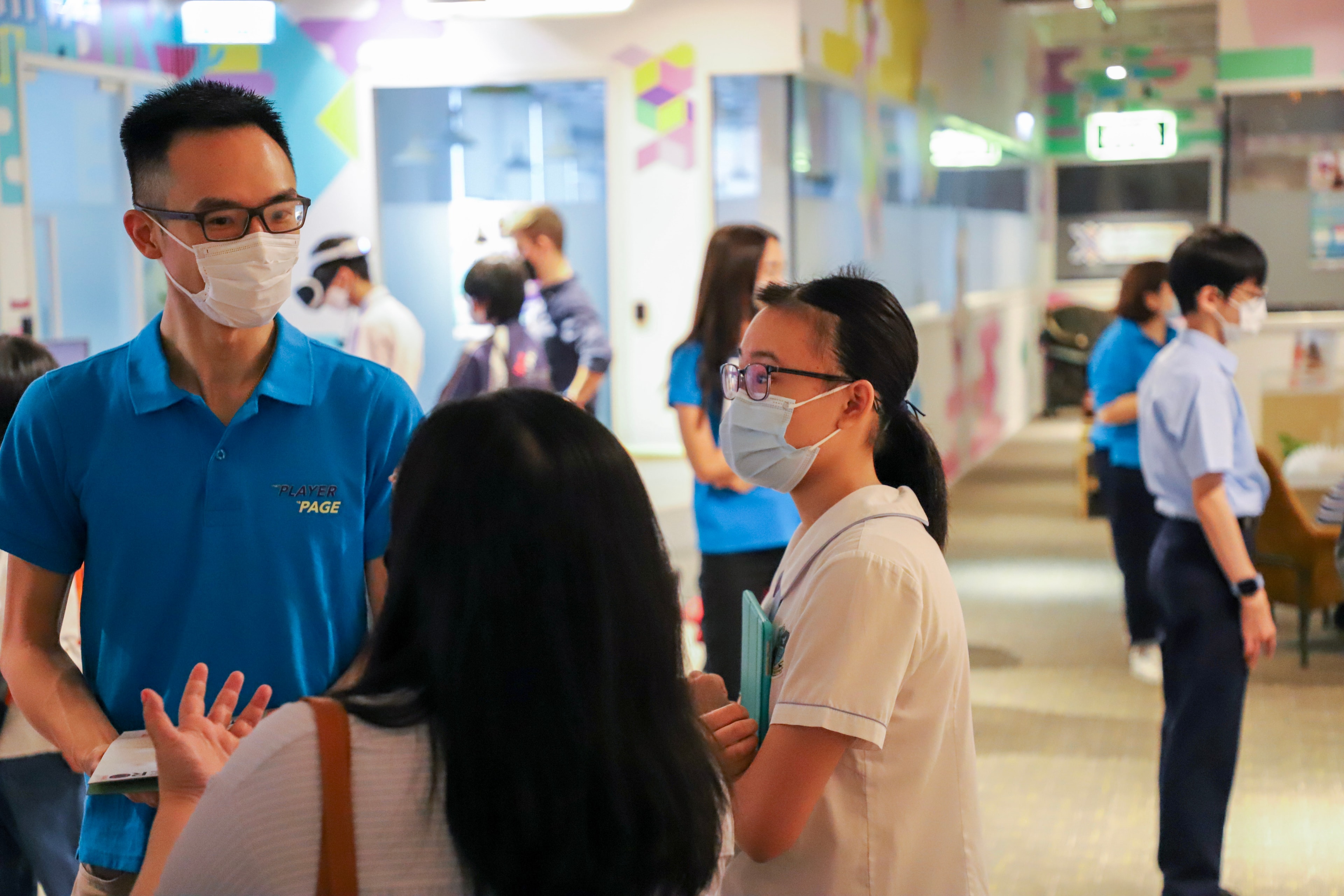 Staff member assisting a visitor at the event