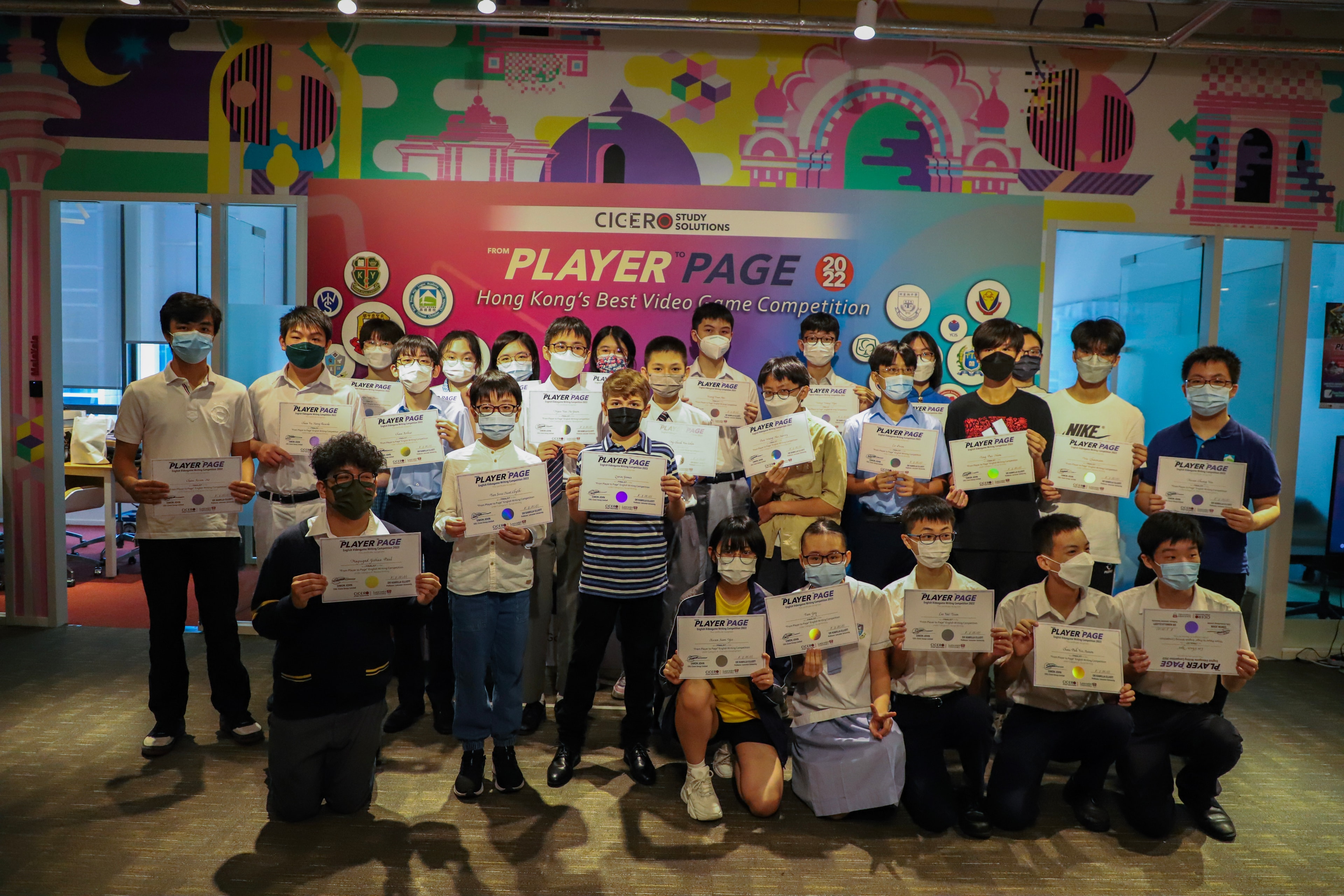 Youth video game competition winners holding certificates