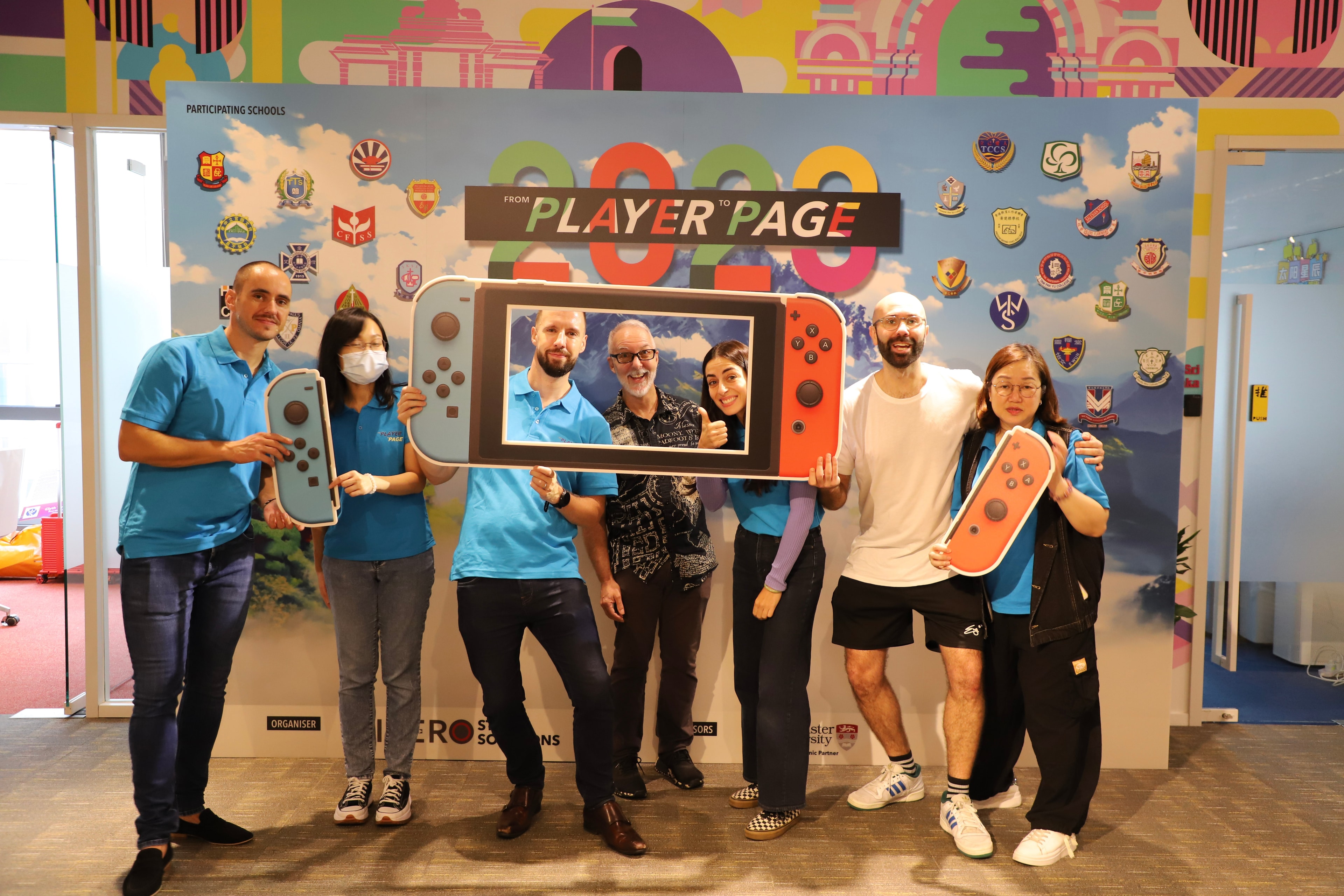 Group posing with giant Nintendo Switch prop