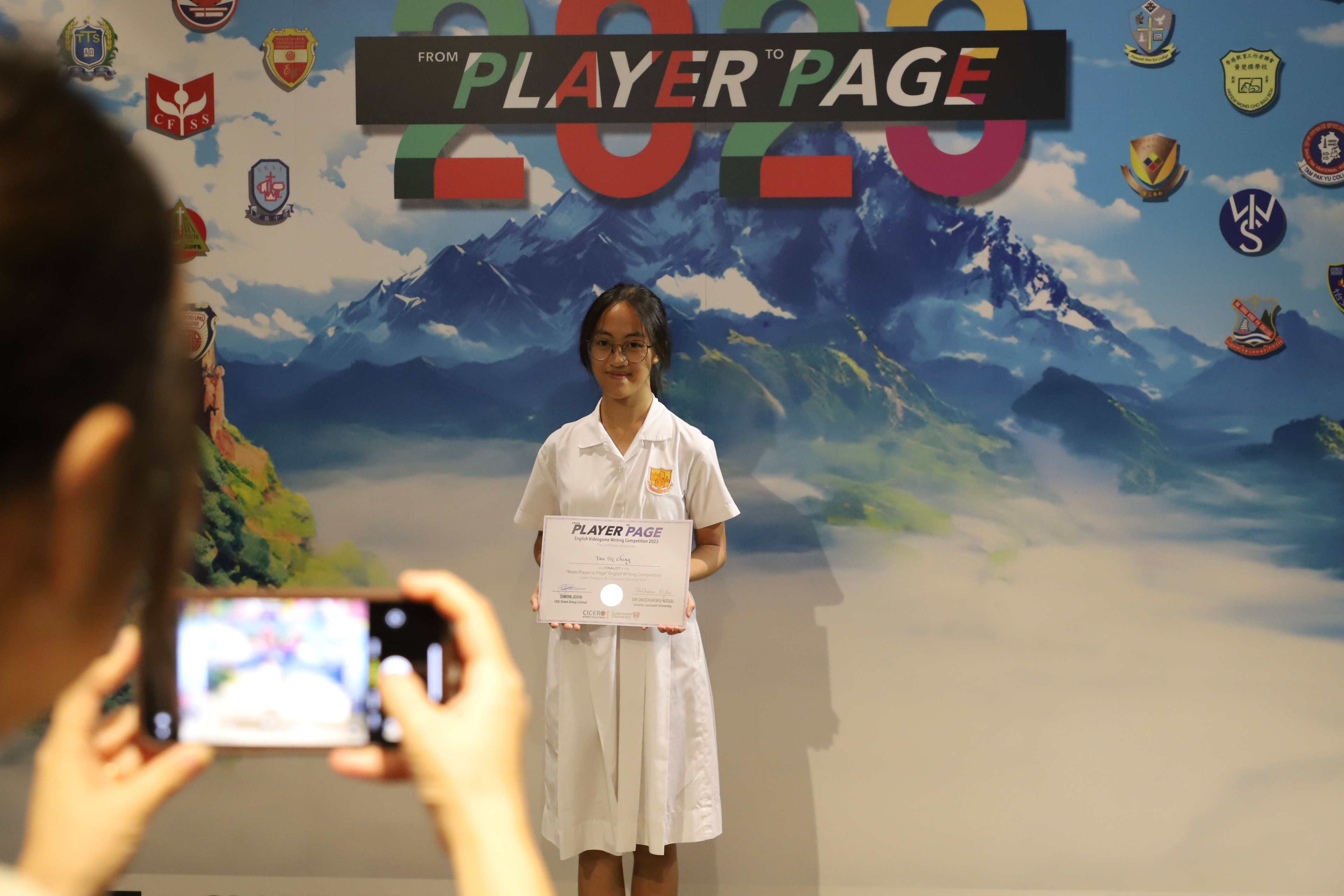Student receiving From Player to Page award certificate