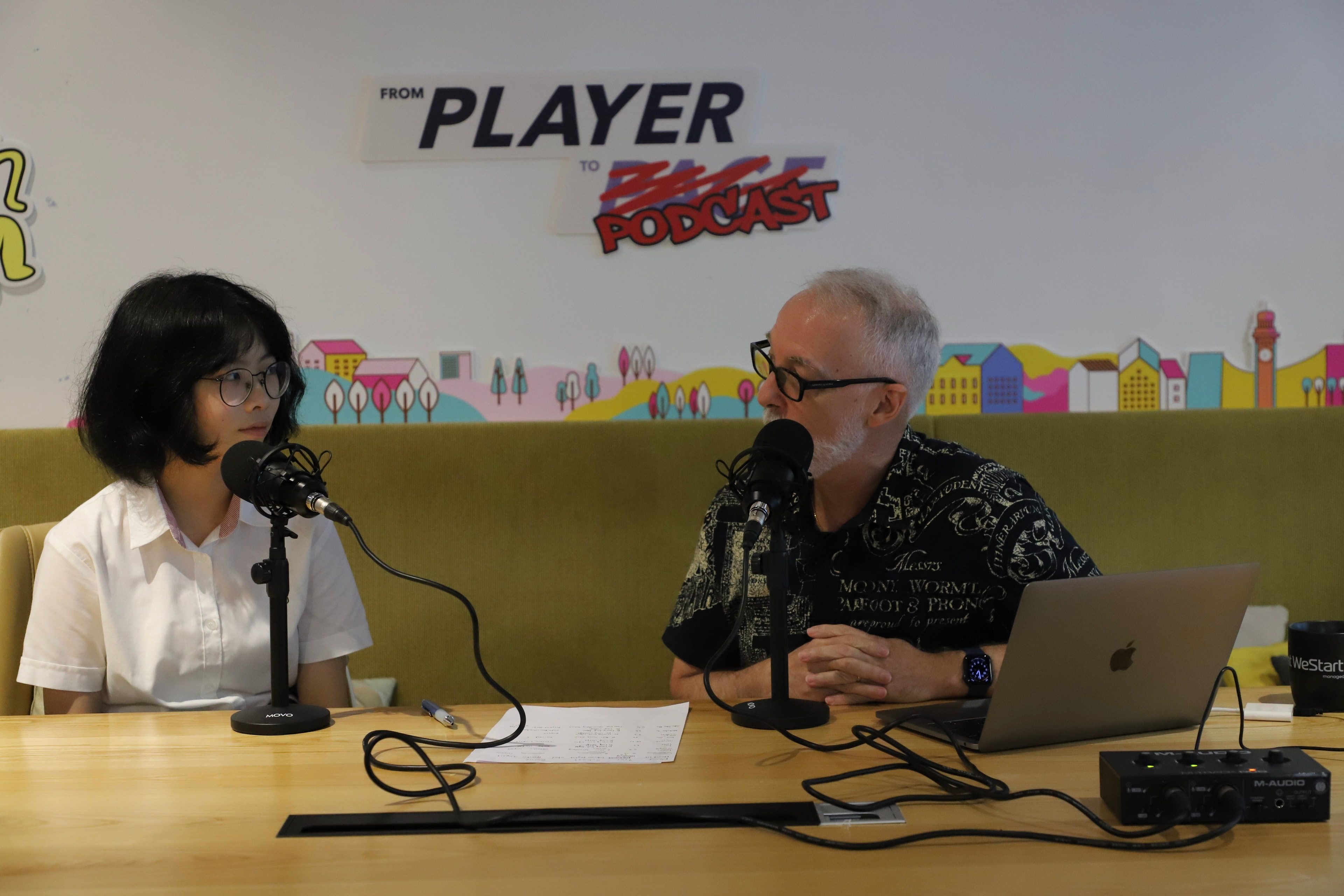 Two people recording podcast conversation