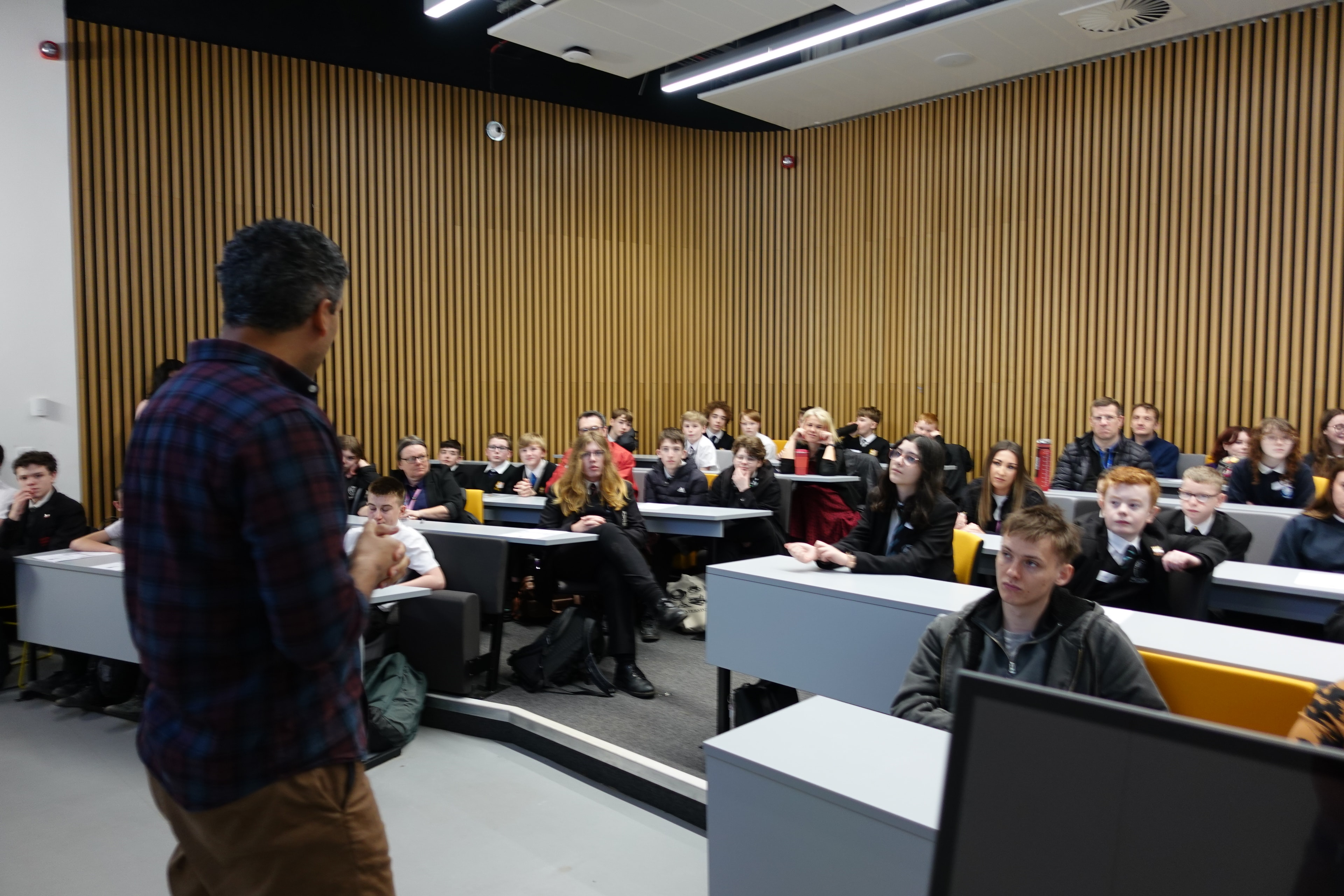 Speaker presenting to a full lecture hall